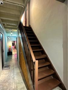 a stairwell in a building with wooden steps at Swing & Pillows @ Beach Street in George Town