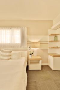 a white bedroom with a bed and a window at The Local House in Miami Beach +43 photos