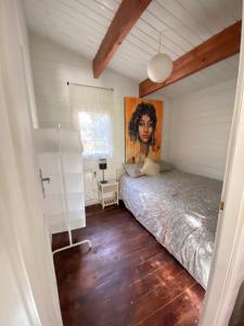 a bedroom with a bed and a painting on the wall at Desconexión y paz, cabaña en la sierra in Albalate de Zorita +43 photos