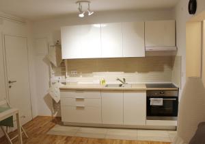a kitchen with white cabinets and a sink at 3L in Samobor