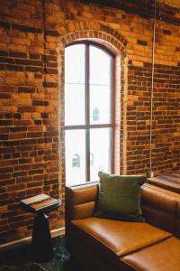 a leather couch in a room with a brick wall at Three Trails in Elkin