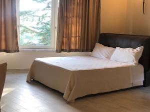 Una cama o camas en una habitación de Podere Maison Délices