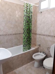 y baño con aseo y cortina de ducha. en DUPLEX DEVoTO 5238 en Buenos Aires