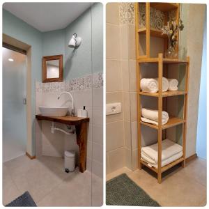 uma casa de banho com um lavatório e uma prateleira com toalhas em Olivea em Dobrovo