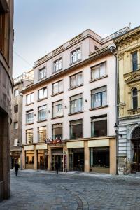 a large white building on a city street at Art Hotel William in Bratislava