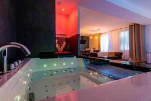 a large bath tub in a living room at Suite and Spa 21 in Dijon