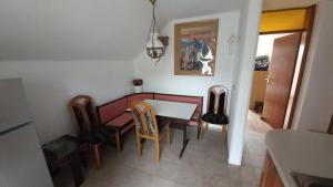 a kitchen and dining room with a table and chairs at Draga - 2 bedroom apartment in Tržič