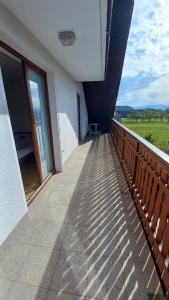 a balcony of a building with a view of a field at Draga - 2 bedroom apartment in Tržič
