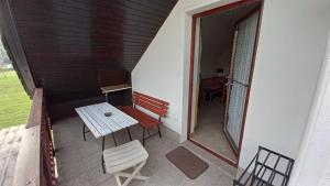 a balcony with a bench and a table and chairs at Draga - 2 bedroom apartment in Tržič