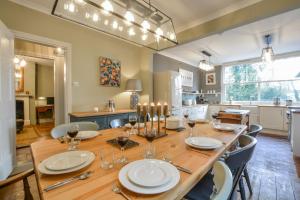 a dining room with a table and chairs and a kitchen at Brook House in Woodbridge