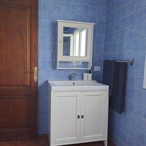 a bathroom with a white sink and a mirror at Casa Mar y Lava in El Golfo