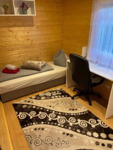 a room with two beds and a desk and a chair at Holiday Home Tettnang Walchesreute in Tettnang