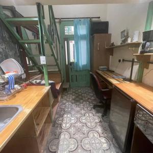 a room with a kitchen with a sink and a desk at Mini Loft 2 en El CIrculo in Guatemala