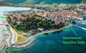 une vue aérienne sur une petite île dans l'eau dans l'établissement Apartments Nautilus, nearby beach Svetilnik, à Izola