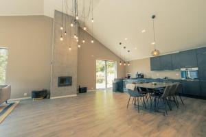 a kitchen with a table and chairs in a room at Modalen Fjord Cottage in Mo