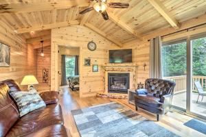 a living room with a couch and a fireplace at Clover Cabin with Hot Tub and Deck in Hocking Hills! in Logan