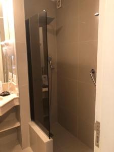 a shower with a glass door in a bathroom at Green Park in Punta del Este