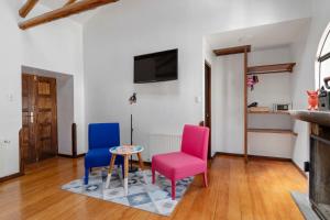 ein Wohnzimmer mit 2 Stühlen und einem Tisch in der Unterkunft Andenes in Cusco