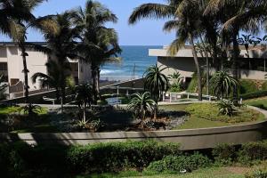 a view of the ocean from the balcony of a resort at Surfside Ballito - Family Only in Ballito