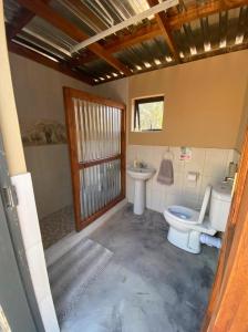 a bathroom with a toilet and a sink at Vlakkieskraal Farmstay - Nyala Tented Camp in Bela-Bela