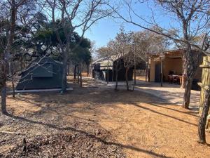 a view of the outside of a house with trees at Vlakkieskraal Farmstay - Nyala Tented Camp in Bela-Bela