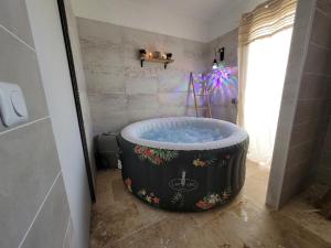 a bathroom with a large tub in a room at Villa 6 couchages spa privatif, accès direct mer, piscine in Le Barcarès