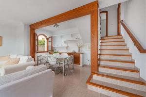 a living room with a white couch and a table at SES ONES with sea views in Alcudia