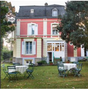 een tafel en stoelen voor een huis bij VILLA LA VISTULE in Dinard