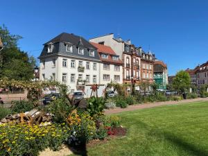 a large white building with a black roof at Studio le pied de Bœuf in Wissembourg