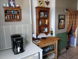 a kitchen with a coffee maker on a counter at Cute 1-bed cottage with view across park. in Issac