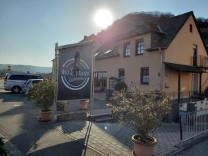 a sign for a restaurant in front of a building at Mosel-Auszeit in Klüsserath