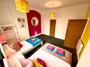 a small room with two beds and a mirror at Market Street Casa by KP in Nottingham