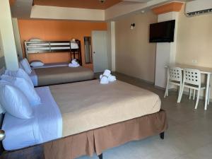 a hotel room with two beds and a television at Aqua by Dreams Hotel 