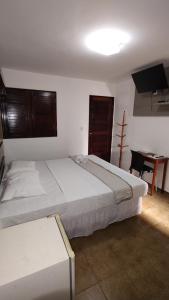 Uma cama ou camas num quarto em Hotel Pousada Bossa Nova