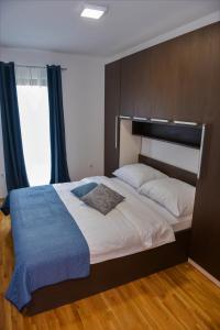 a bedroom with a large bed with a large window at Holiday home Maša - Kupres in Kupres