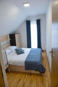 a bedroom with a bed and a window at Holiday home Maša - Kupres in Kupres