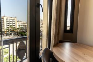 a table and a window with a view of a city at Tendillas Plaza in Córdoba