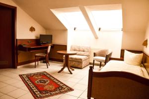 a bedroom with a bed and a desk and a computer at Hotel Bergwiesen in Lohr am Main