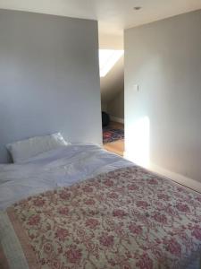 a bedroom with a bed with a rug on the floor at Elegant 3bed Crouchend in style with roof terrace in London