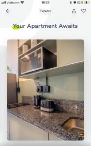 a kitchen with a microwave and a counter top at Batchelor City Studio Apartment in Durban