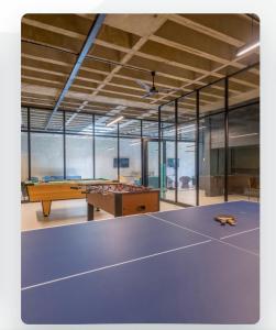 a large room with a ping pong table in it at Batchelor City Studio Apartment in Durban