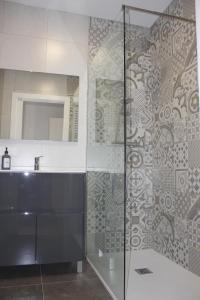 リベス・デ・フレセルにあるApartamentos CAN GUSIのバスルーム(ガラス張りのシャワー、シンク付)