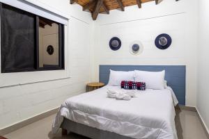 Letto o letti in una camera di Soy Local Guatape