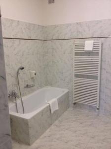 a bathroom with a bath tub in a room at Locanda San Fiorenzo in Fiorenzuola dʼArda