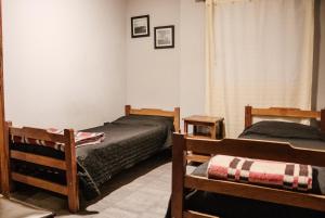 1 dormitorio con 2 camas y ventana en Hostal Namaste en Salta