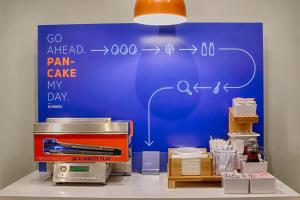 a blue wall with a drawing of a pain cave on it at Holiday Inn Express Chesapeake - Norfolk by IHG in Chesapeake