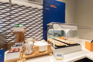 a display case with donuts and other pastries at Holiday Inn Express Chesapeake - Norfolk by IHG in Chesapeake