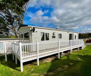 a white mobile home with a white porch at Newquay Bay Resort - Summer Days 135 in Porth