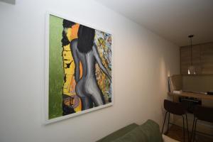 a painting of a woman hanging on a wall at Studio apartment Art Zone in Podgorica