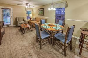 a dining room and living room with a table and chairs at Holiday Inn Club Vacations Villages Resort at Lake Palestine in Flint